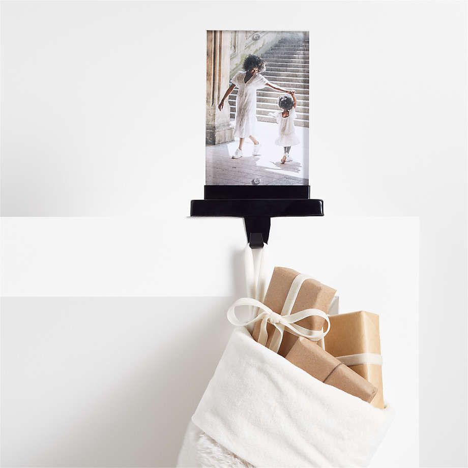 https://cb.scene7.com/is/image/Crate/AcrylicPhotoStckHookBlkSSF22/$web_pdp_main_carousel_med$/220802115335/acrylic-photo-frame-christmas-stocking-hook.jpg