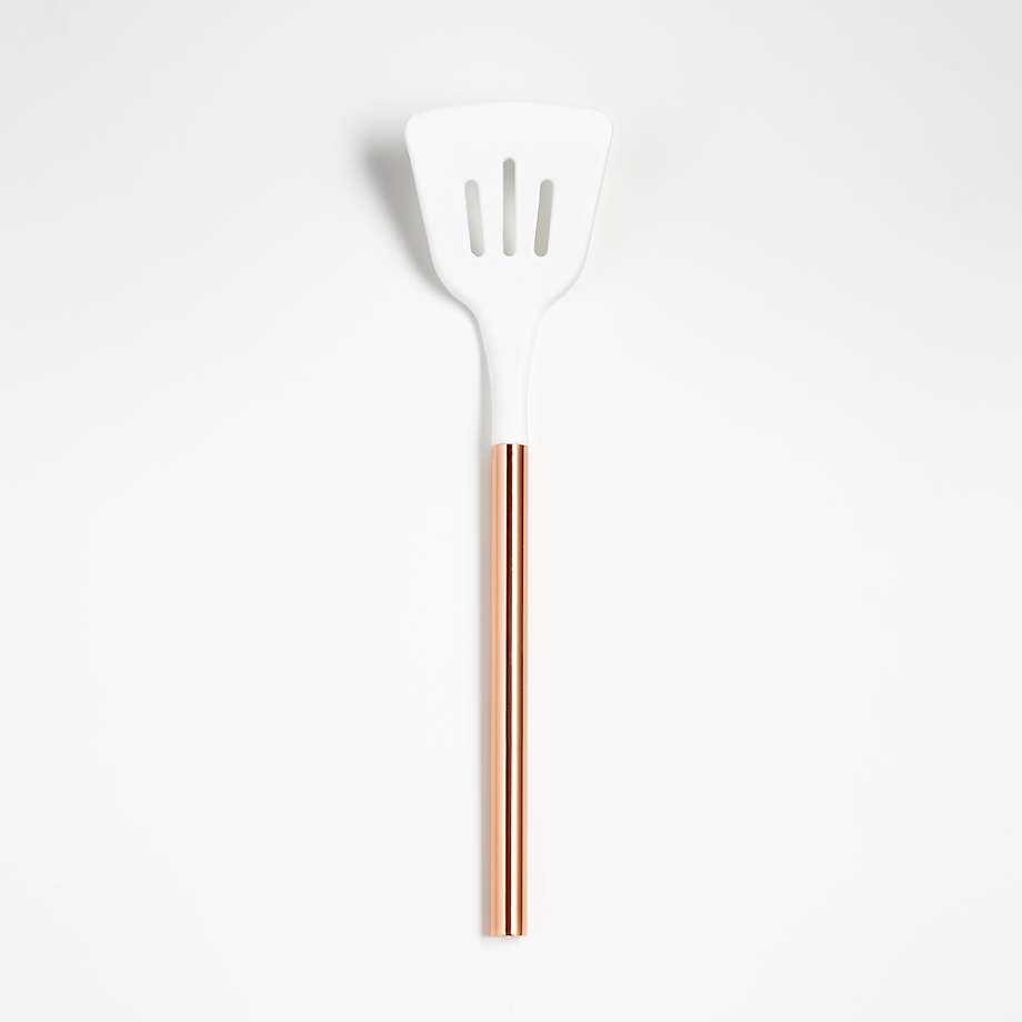 https://cb.scene7.com/is/image/Crate/AdaWhiteCopperSltdTurnerSSS21/$web_pdp_main_carousel_med$/201016100936/ada-white-silicone-slotted-turner-with-copper-handle.jpg