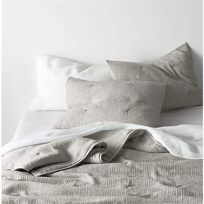 https://cb.scene7.com/is/image/Crate/AireOrgBlndCrnklBeddingPGFSSF22/$web_pdp_main_carousel_low$/220712120501/aire-crinkle-organic-cotton-pebble-grey-quilts-and-pillow-shams.jpg
