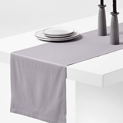 https://cb.scene7.com/is/image/Crate/AspenOrgCtnRnnr120inMGrySSS23/$web_pdp_carousel_med$/221227095009/aspen-metal-grey-organic-cotton-table-runner.jpg