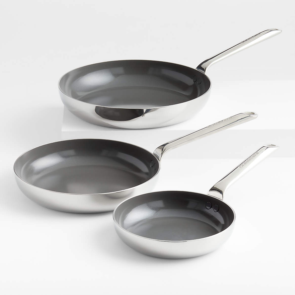 https://cb.scene7.com/is/image/Crate/CBEvnckCrCrmcFryPanS3SSF22/$web_pdp_main_carousel_zoom_med$/220505165922/crate-and-barrel-evencook-core-ceramic-non-stick-fry-pans-set-of-3.jpg