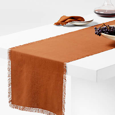 https://cb.scene7.com/is/image/Crate/CraftOrgCtnFrgRnnrAlmBrnSSS23/$web_pdp_carousel_med$/221227095009/craft-almond-brown-organic-cotton-fringe-table-runner.jpg