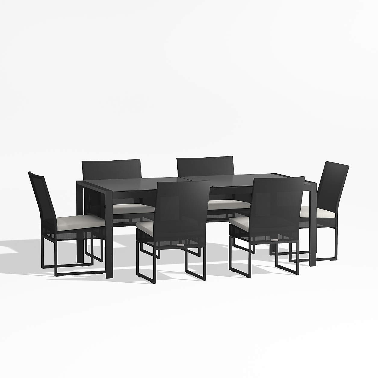 Dune black glass outdoor dining table set with white cushions crate