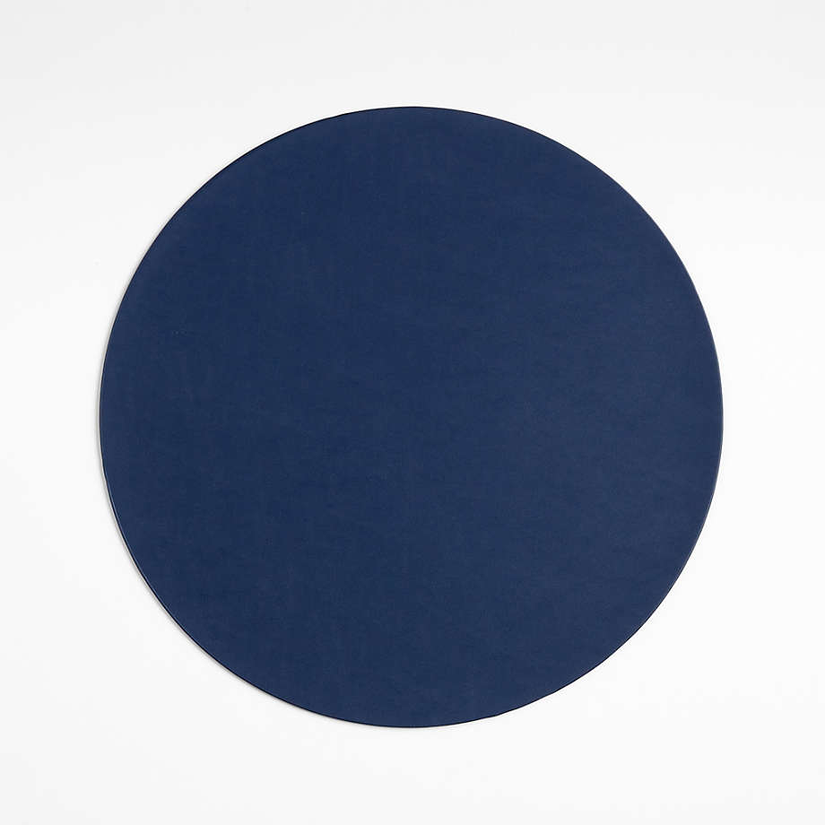 https://cb.scene7.com/is/image/Crate/FauxLthrRndPlcmtNavySSF23/$web_pdp_main_carousel_med$/230817133345/rizzo-round-reversible-navy-and-natural-faux-leather-placemat.jpg