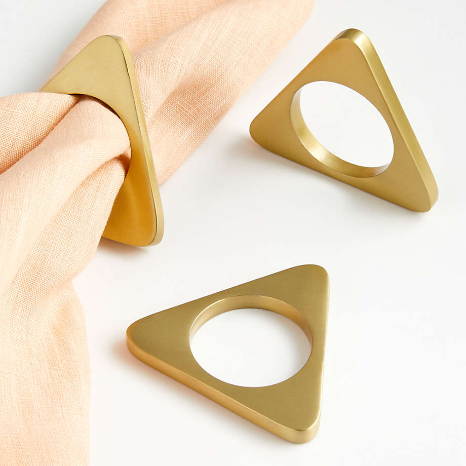 https://cb.scene7.com/is/image/Crate/GoldTriangleNapkinRingSSF20/$web_pdp_main_carousel_med$/200430092652/gold-triangle-napkin-ring.jpg