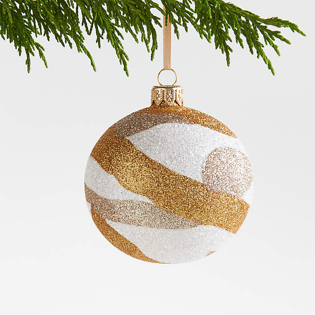 https://cb.scene7.com/is/image/Crate/GoldWhiteGlitterSwirlBallSSF23/$web_pdp_main_carousel_zoom_low$/230705114007/gold-and-white-glitter-glass-ball-christmas-tree-ornament.jpg