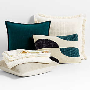 https://cb.scene7.com/is/image/Crate/IndoorPillowThrowNwGreenFSSS24/$web_plp_card_mobile$/231117110030/ivory-and-sea-green-throw-pillow-arrangement.jpg