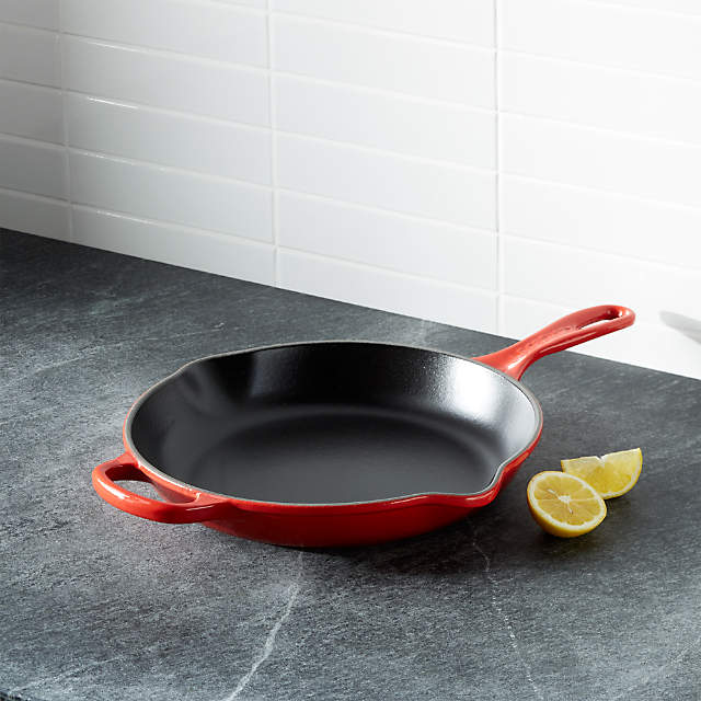 https://cb.scene7.com/is/image/Crate/LeCreuSig10inSkilletChrrySHF16/$web_pdp_main_carousel_zoom_low$/220913133313/le-creuset-signature-10-cherry-red-skillet.jpg