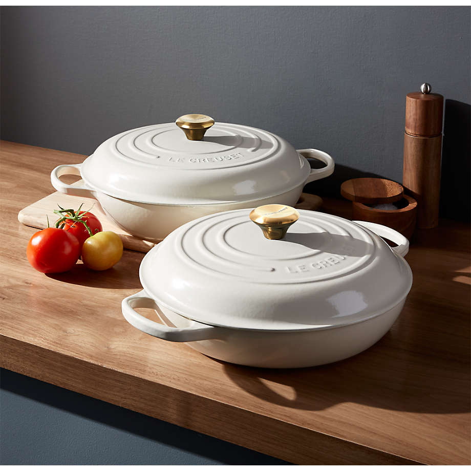 https://cb.scene7.com/is/image/Crate/LeCreuSigEvdyPnCreamGroupFHF20/$web_pdp_main_carousel_med$/200814140339/le-creuset-signature-cream-everyday-pans.jpg