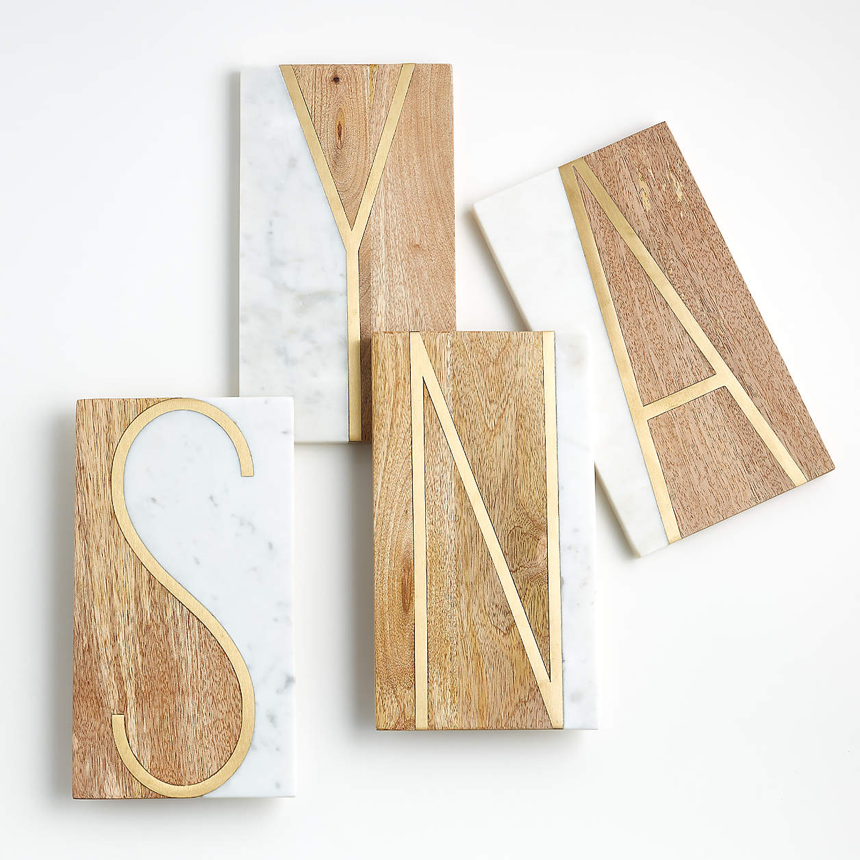 overhead photo of wood and marble monogrammed serving boards. 