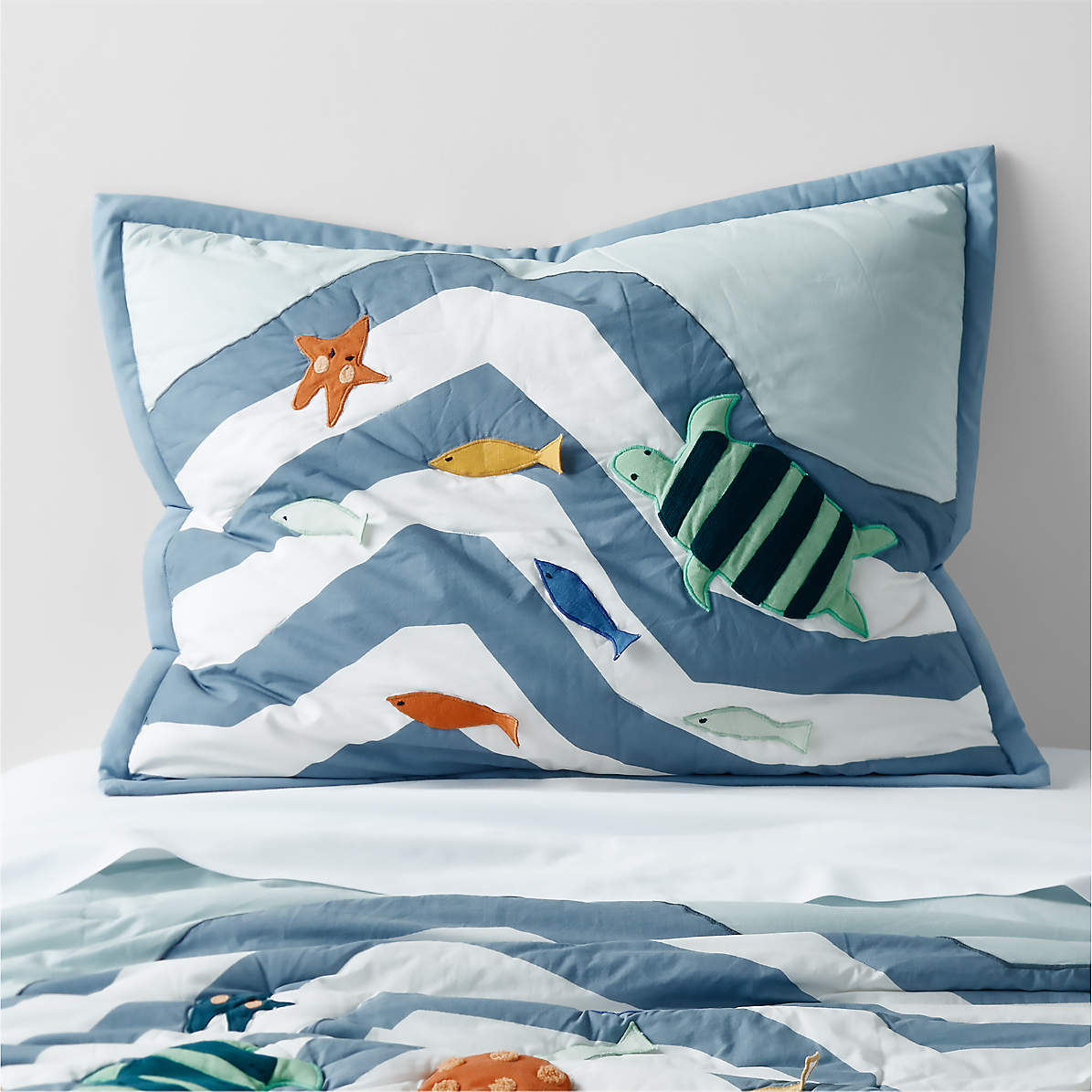 https://cb.scene7.com/is/image/Crate/SubmarineOrgShamSSF22/$web_pdp_main_carousel_zoom_med$/221104104437/submarine-kids-organic-blue-pillow-sham.jpg