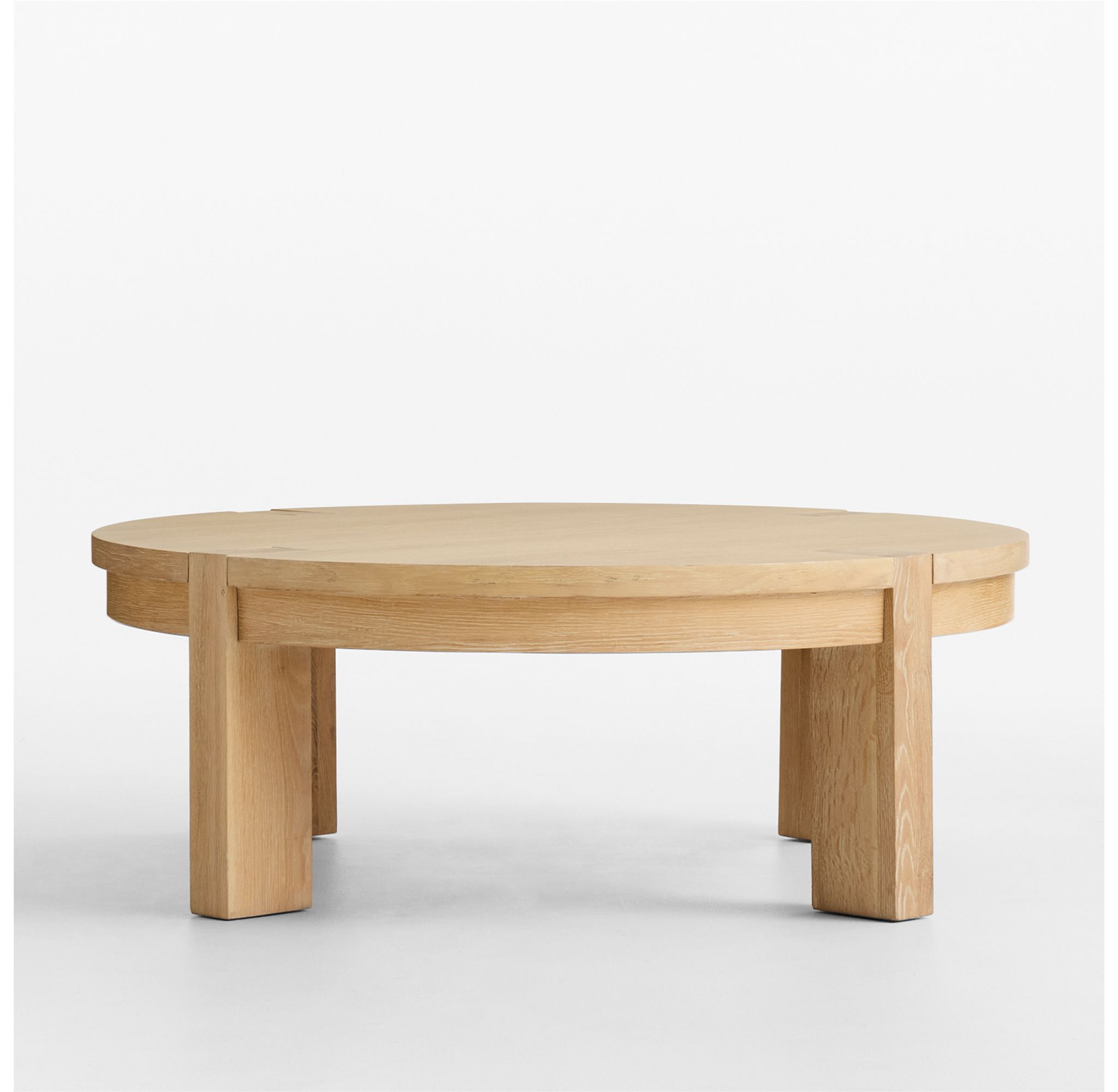 Front view of a round white oak coffee table.