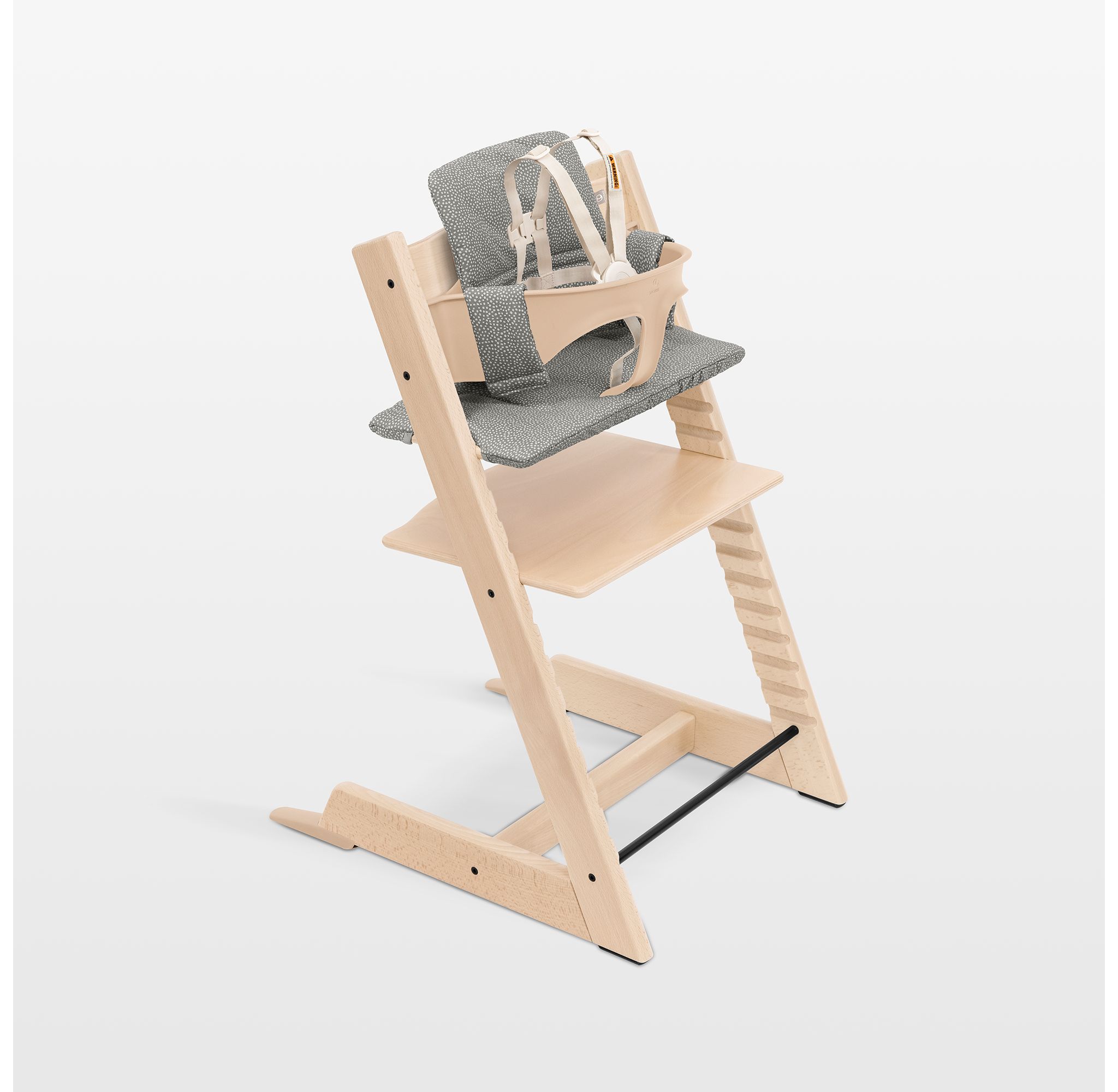 Stokke Tripp Trapp high chair in natural wood finish.