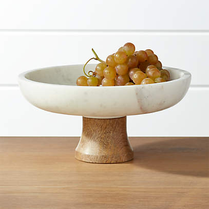 https://cb.scene7.com/is/image/Crate/WoodMarbleFootedFruitBowlSHF18/$web_pdp_main_carousel_low$/220913135441/wood-and-marble-footed-fruit-bowl.jpg