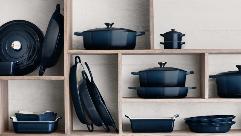 blue cookware stacked on shelves