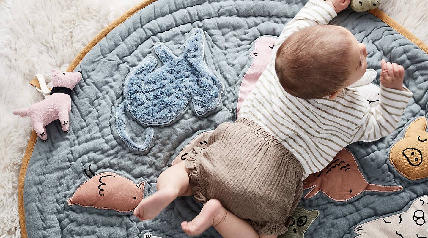 baby playing on mat